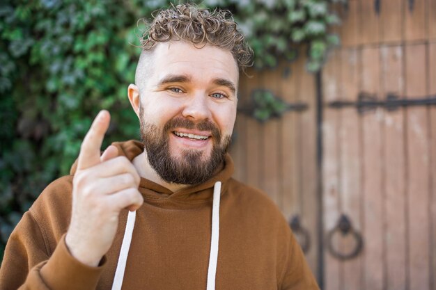 Handsome curly man takes a video of himself video blog and youth blogger concept