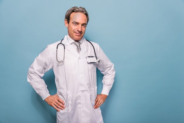 Handsome doctor portrait on blue wall