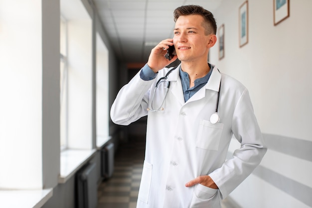 Handsome doctor talking on phone