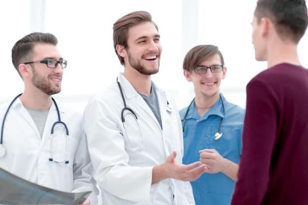 Handsome doctor talking with the patient