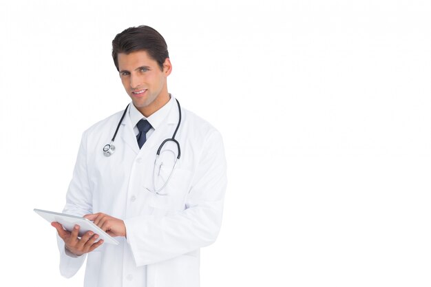 Handsome doctor using a tablet