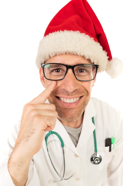 Handsome doctor with christmas hat wearing a Christmas hat 