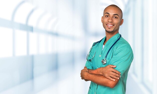 Handsome doctor with stethoscope smiling at camera