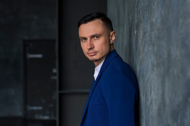 Handsome elegant fashionable young man in a blue jacket