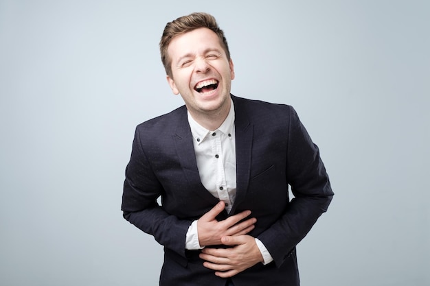 Handsome european man in suit laughing Positive emotion concept