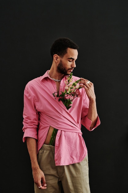 Handsome Fashion Model Posing With Flowers