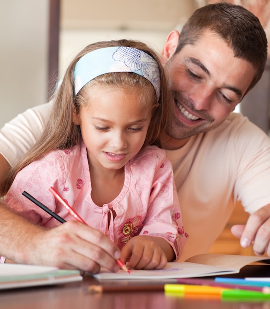 Handsome father helping her daughter for homework