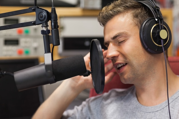 Handsome focused singer recording a song