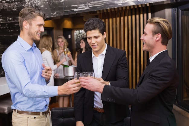 Handsome friends having a drink together