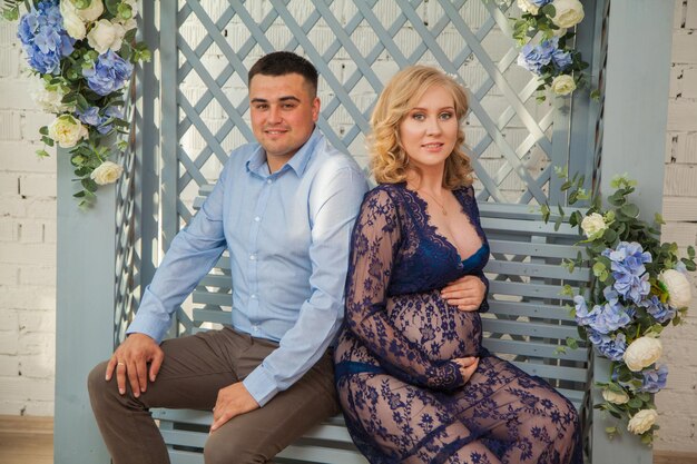 Handsome future parents are sitting in the gazebo