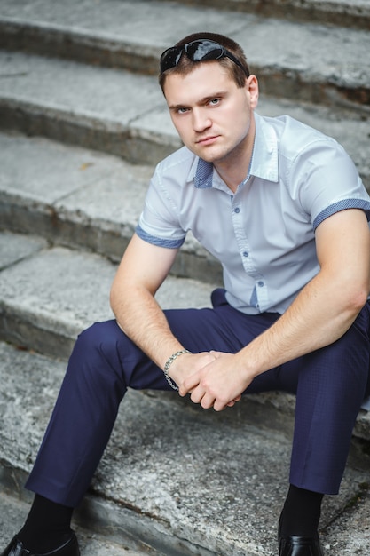 Handsome guy in blue shirt sitting 