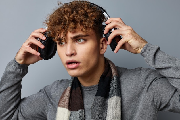 Handsome guy elegant style checkered scarf headphones isolated background