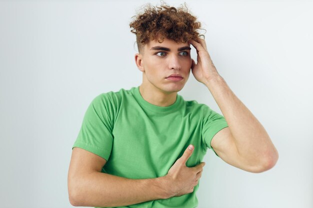 Handsome guy in green tshirts emotions posing unaltered