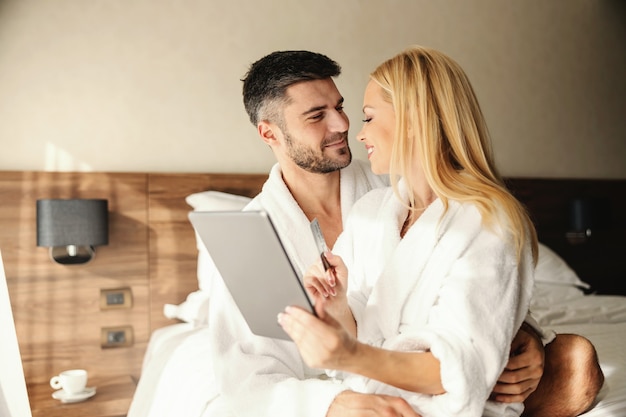 The handsome guy is having his lover in his lap and gently hugging her Online payment Online dinner and spa reservation