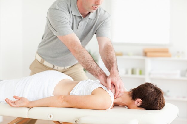 Handsome Guy massaging a cute womans neck