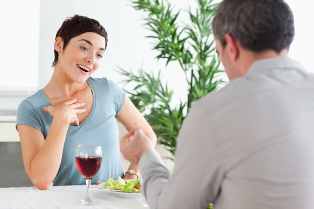 Handsome guy proposing to smiling girlfriend