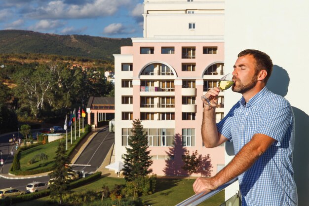 Handsome guy standing on balcony