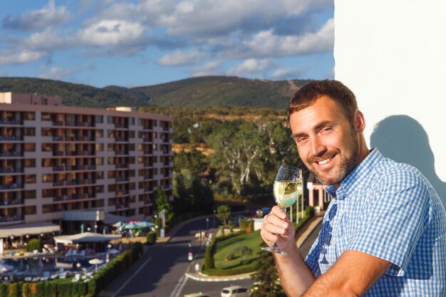 Handsome guy standing on balcony