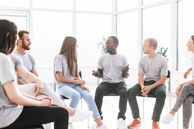 Handsome guy telling his ideas to a group of like-minded people. business and education