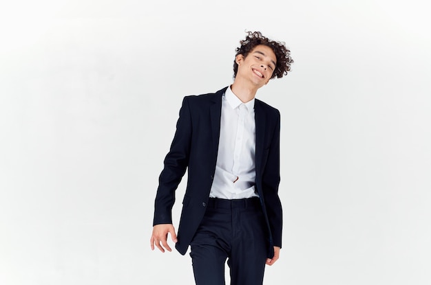 Handsome guy with curly hair and in a jacket shirt pants model