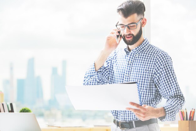 Handsome guy with document on phone