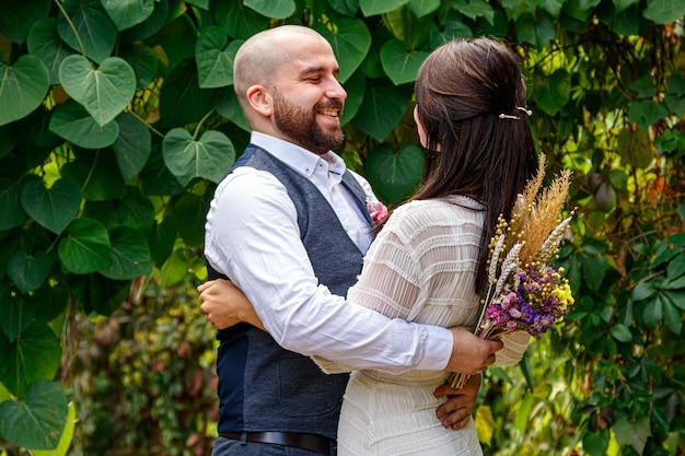 Handsome guy with flowers kisses his fiancee