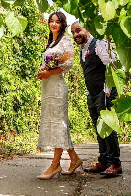 Handsome guy with flowers kisses his fiancee