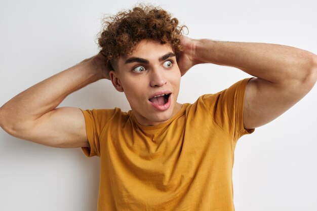 Handsome guy in yellow tshirts gesture hands emotions isolated background