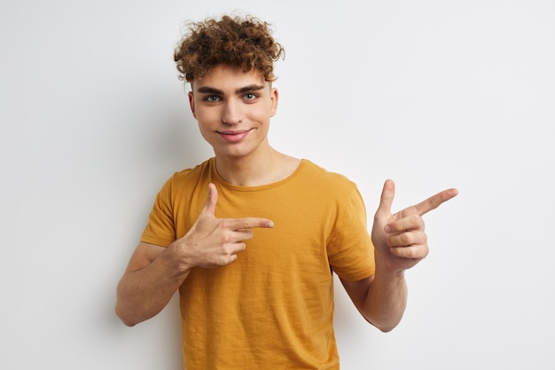 Handsome guy in yellow tshirts gesture hands emotions isolated background