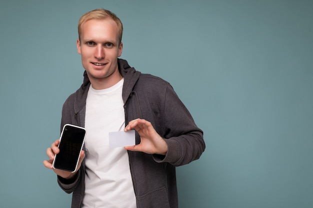 Handsome happy cool young man good looking wearing casual stylish clothes standing isolated over