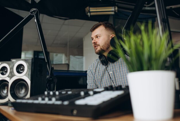 Handsome happy radio host moderating in studio at college