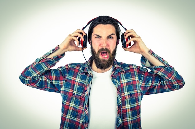 Handsome hipster enjoying listening to music