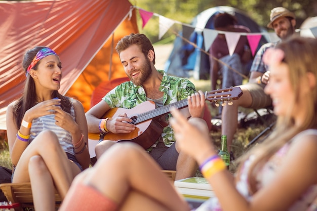 Handsome hipster playing the guitar