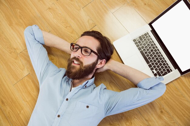 Handsome hipster using his laptop