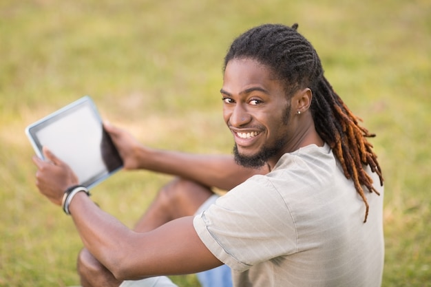 Handsome hipster using his tablet pc