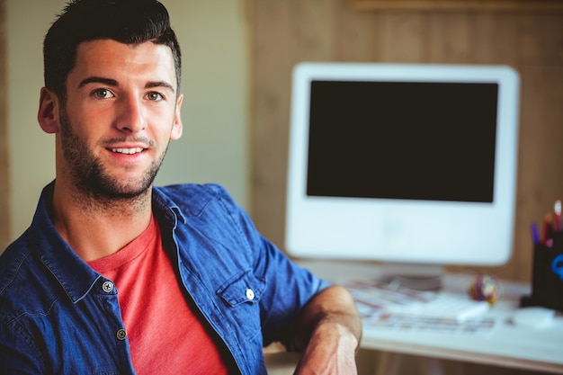 Handsome hipster working at desk