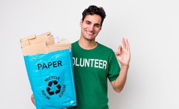 Handsome hispanic man feeling happy showing approval with okay gesture ecology concept