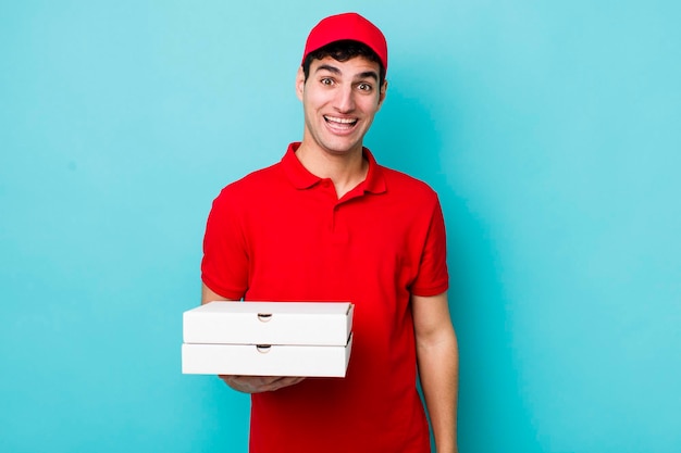 Handsome hispanic man looking happy and pleasantly surprised delivery pizza concept