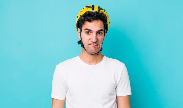 Handsome hispanic man looking puzzled and confused bike concept