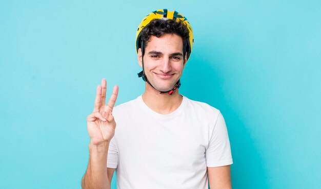 Handsome hispanic man smiling and looking friendly showing number three bike concept