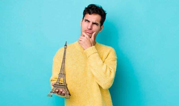 Handsome hispanic man thinking feeling doubtful and confused france concept