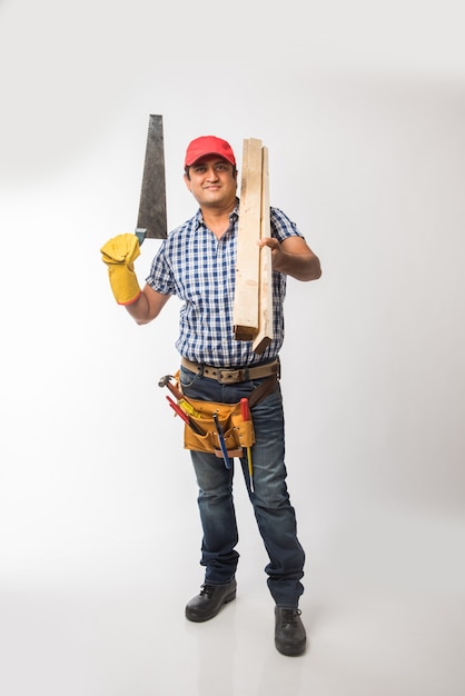 Handsome Indian Carpenter or wood worker in action, isolated