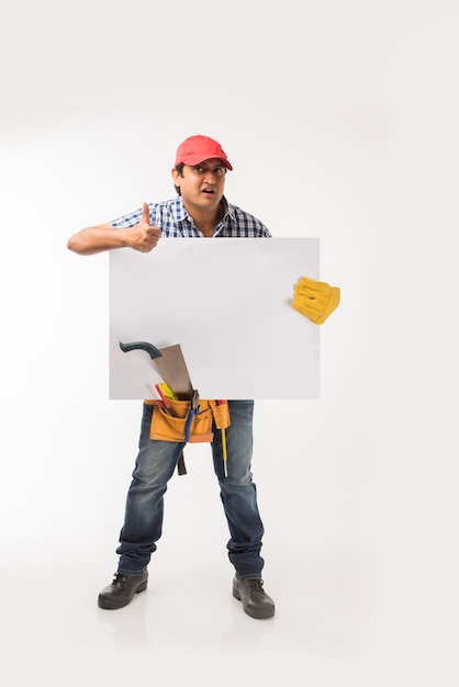 handsome indian carpenter or wood worker in action, isolated