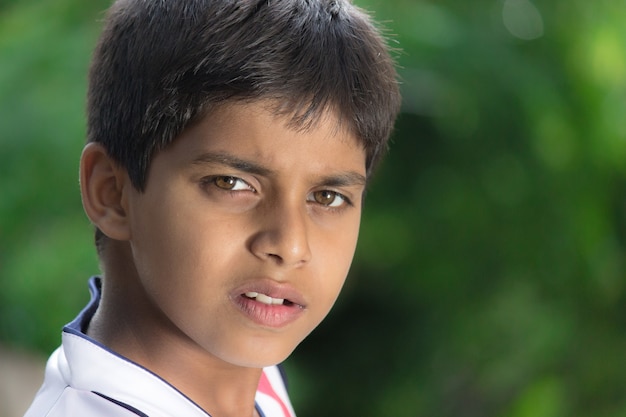 Handsome kid looking into camera Close up emotions of a young kid with serious expression on face