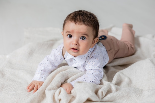 Handsome little boy dressed up laying on blanket card banner health