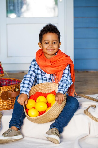 Handsome little preschool boy with basket of fresh lemons