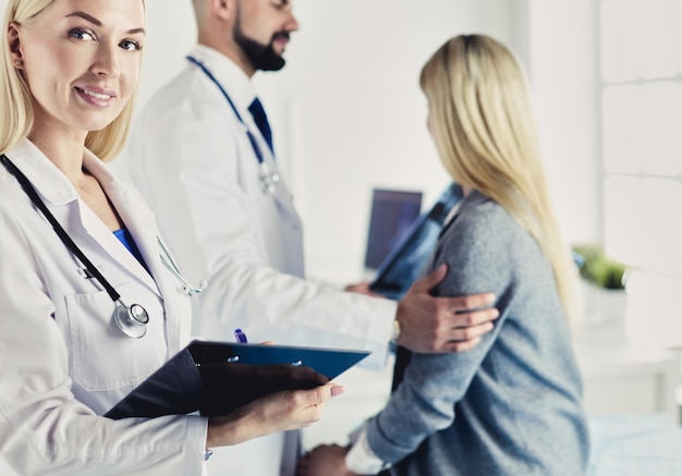 Handsome male doctor consulting a couple about infertility in his medical office