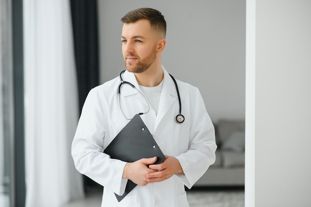 Handsome male doctor portrait in office