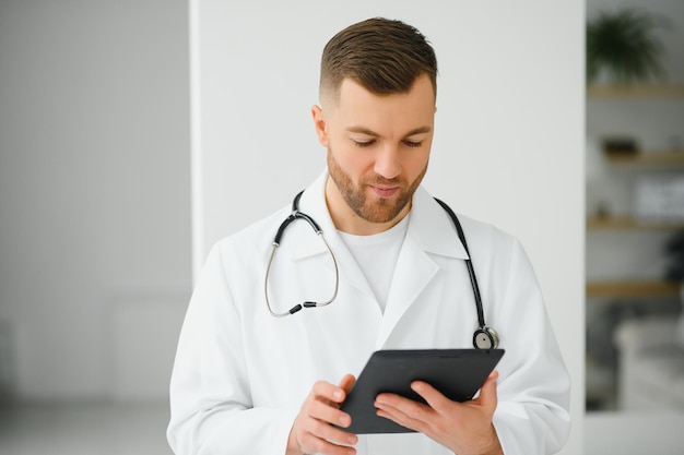 Handsome male doctor portrait in office