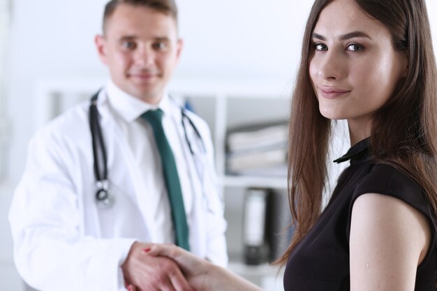 Handsome male doctor shake hand